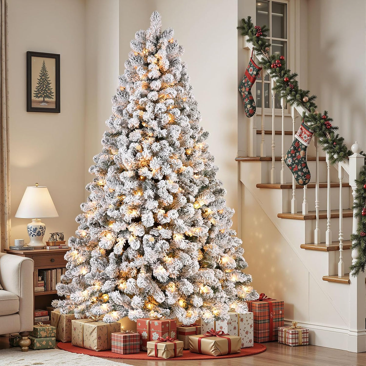 Full snow-flocked Christmas tree with warm lights beside a staircase and wrapped gifts.
