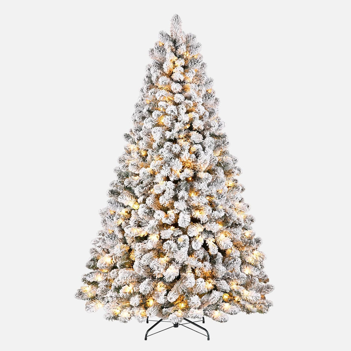 Full view of a snow-flocked spruce tree with warm lights and a black stand on a white background.
