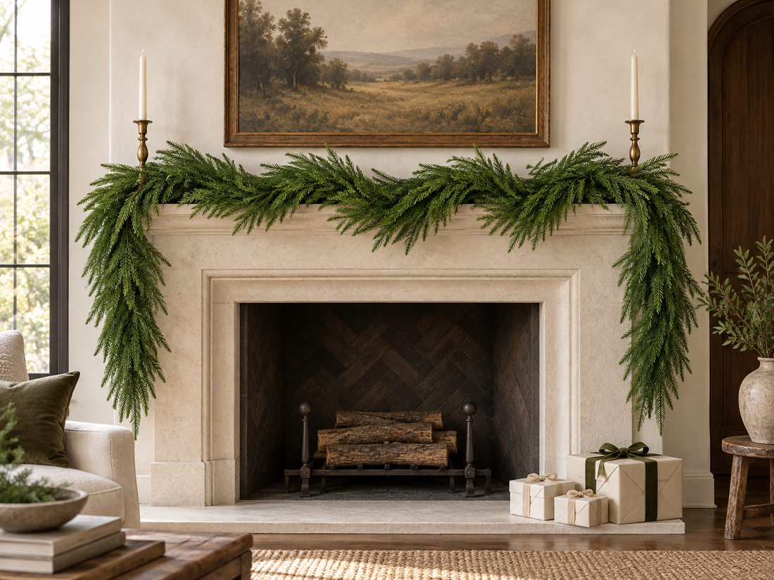 DRNEWI styling scene. An unlit Norfolk pine garland draped across a pale stone fireplace mantel. AI-generated lifestyle scene based on the product image; accessories shown for styling.